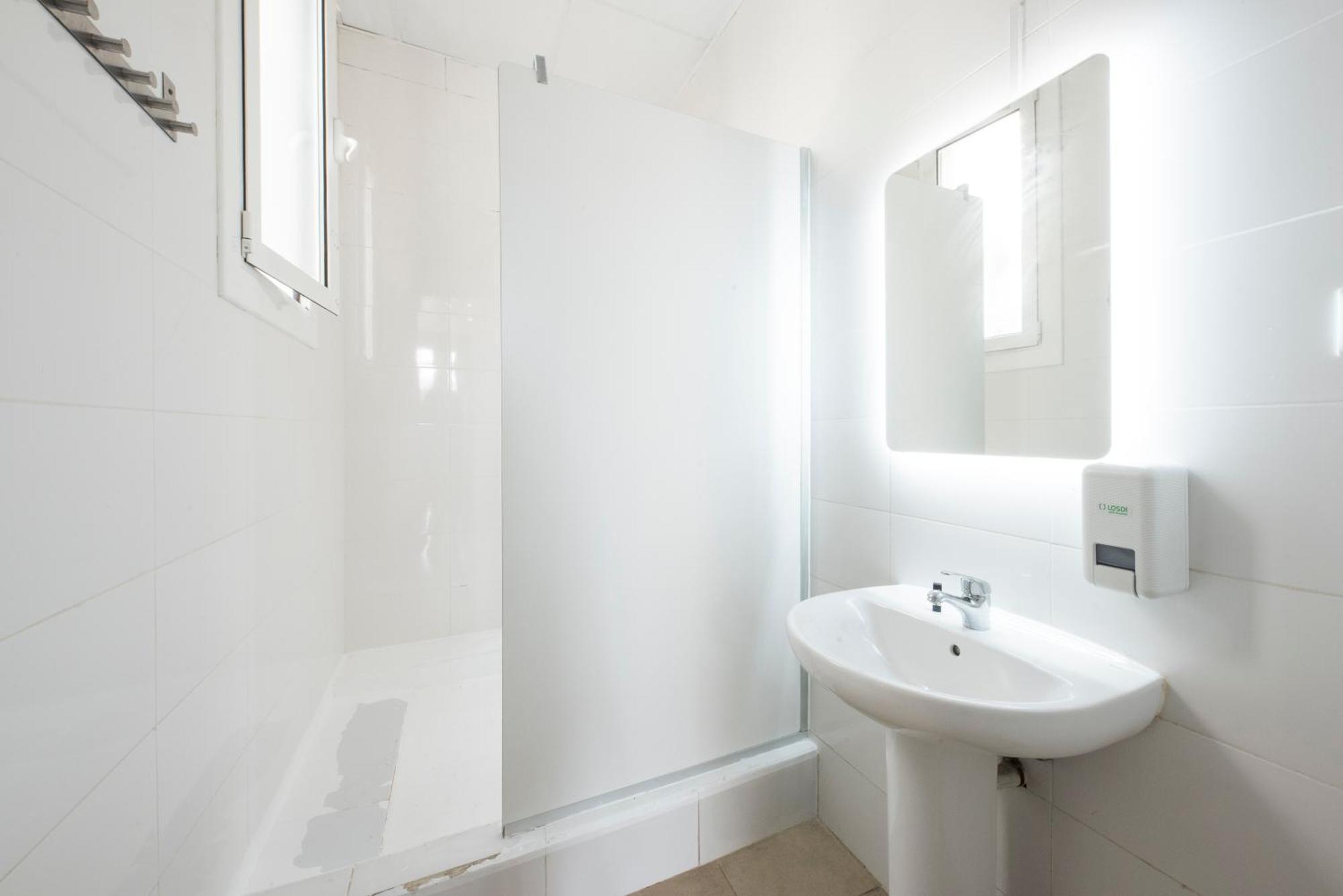 Cama en habitación compartida para mujeres de 12 camas con baño